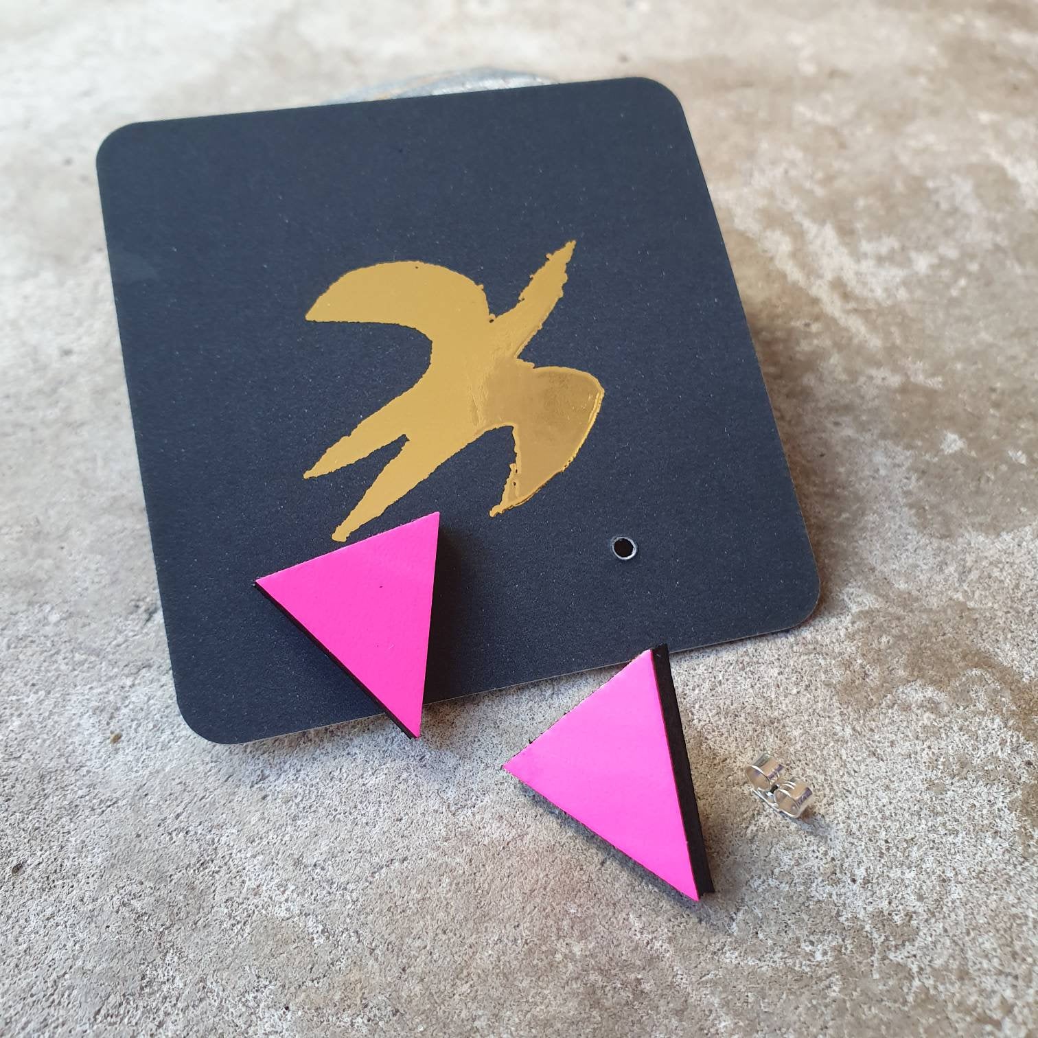 Neon pink triangular stud earrings