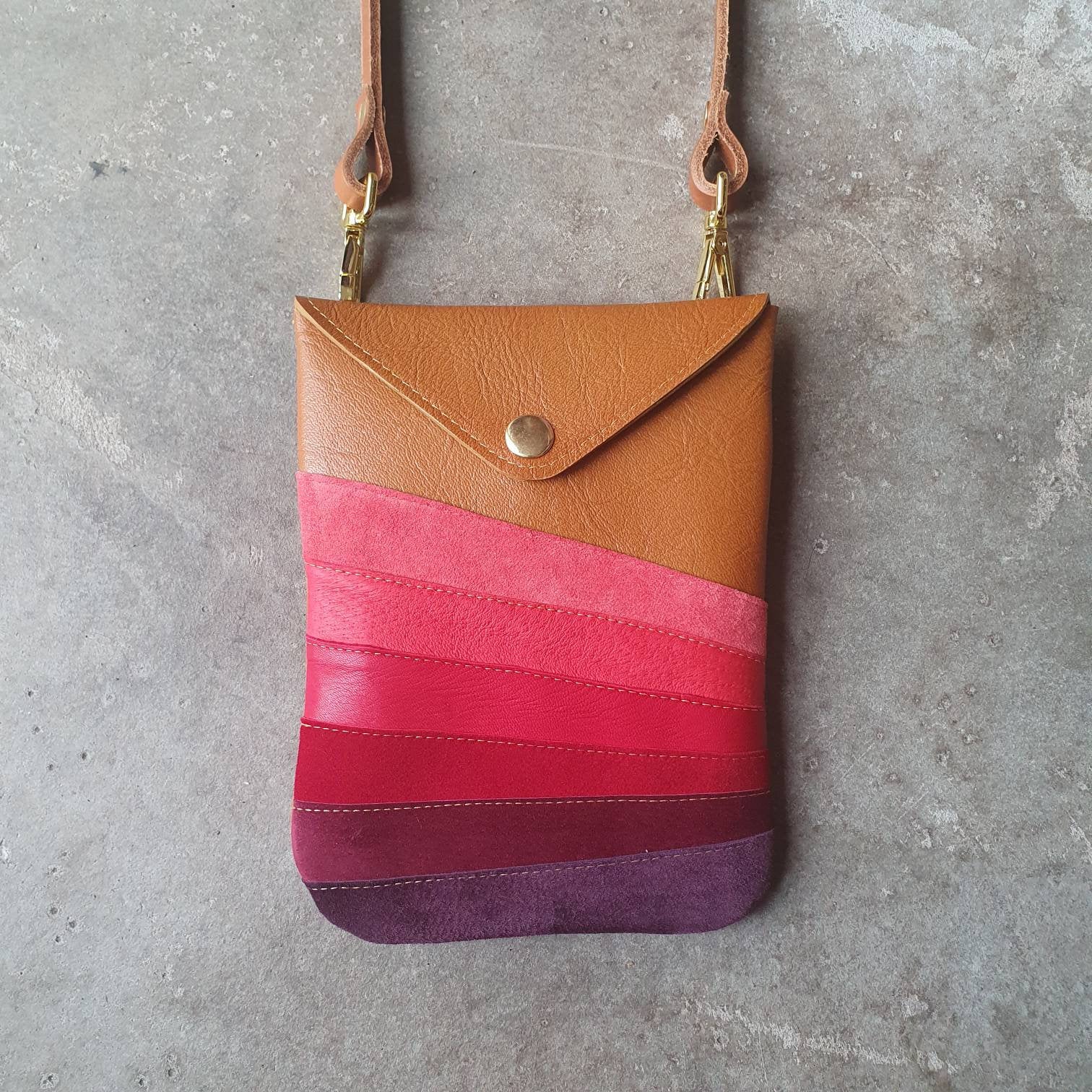 Tan leather handmade handbag with multiple shades of red stripes