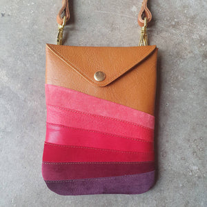 Tan leather handmade handbag with multiple shades of red stripes