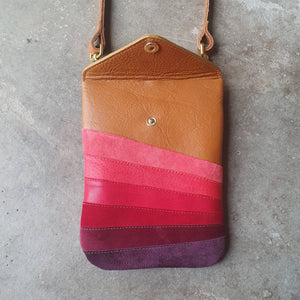 Tan leather handmade handbag with multiple shades of red stripes