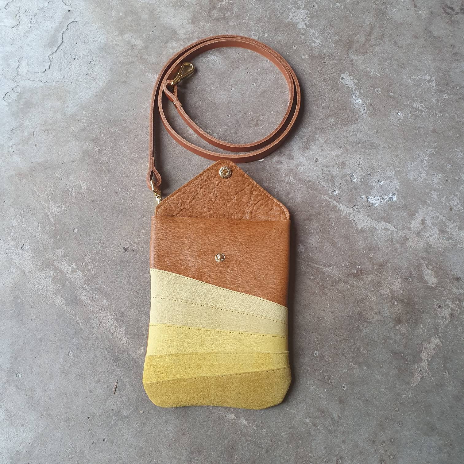 Tan leather crossbody handmade handbag with multiple shades of yellow stripes