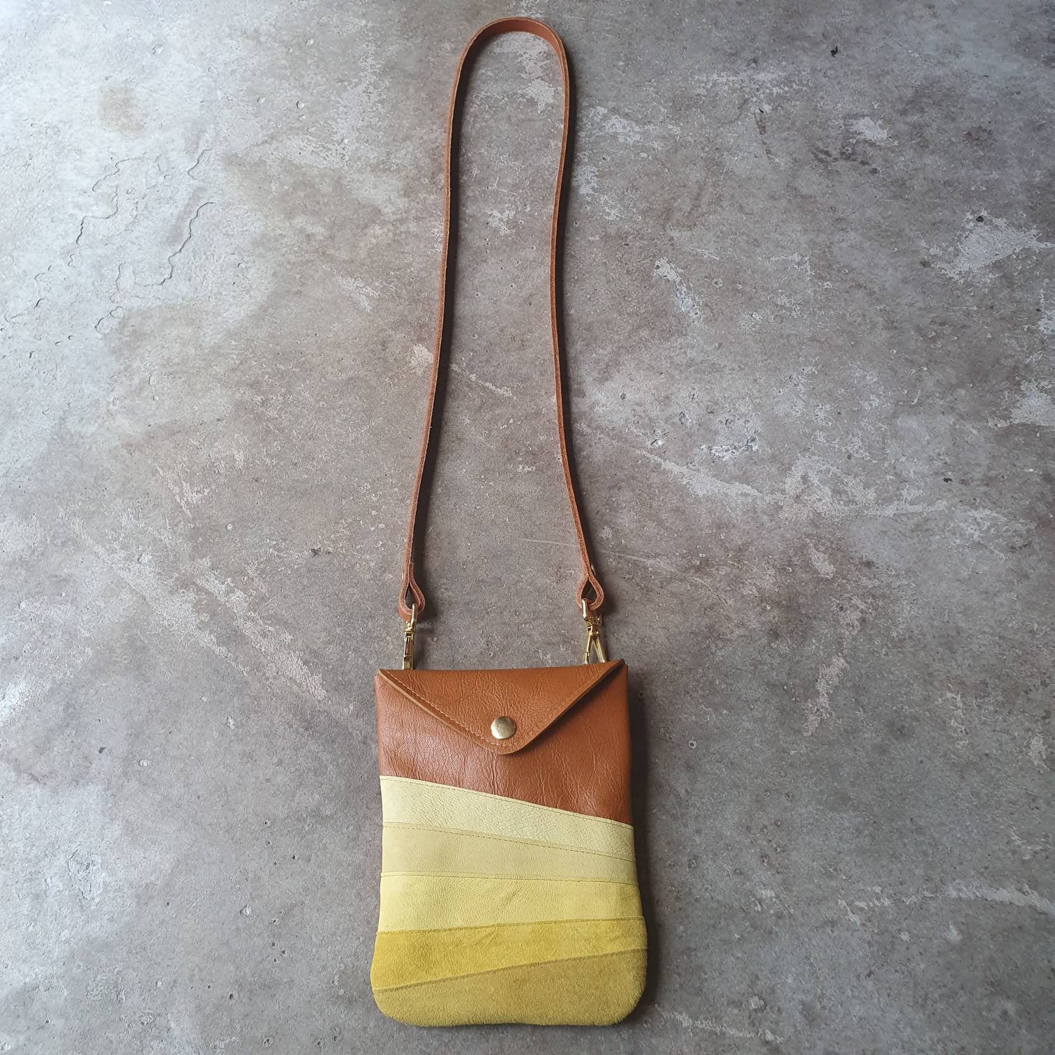 Tan leather crossbody handmade handbag with multiple shades of yellow stripes