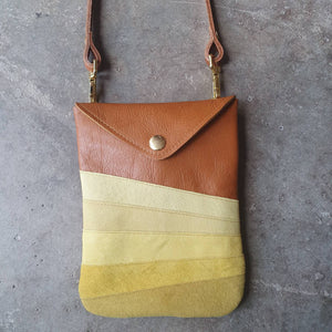 Tan leather crossbody handmade handbag with multiple shades of yellow stripes