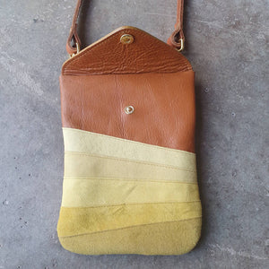 Tan leather crossbody handmade handbag with multiple shades of yellow stripes