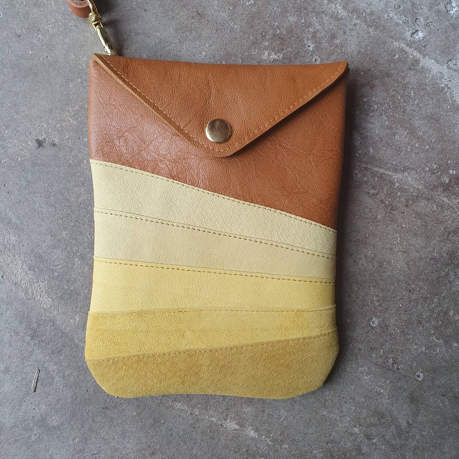 Tan leather crossbody handmade handbag with multiple shades of yellow stripes