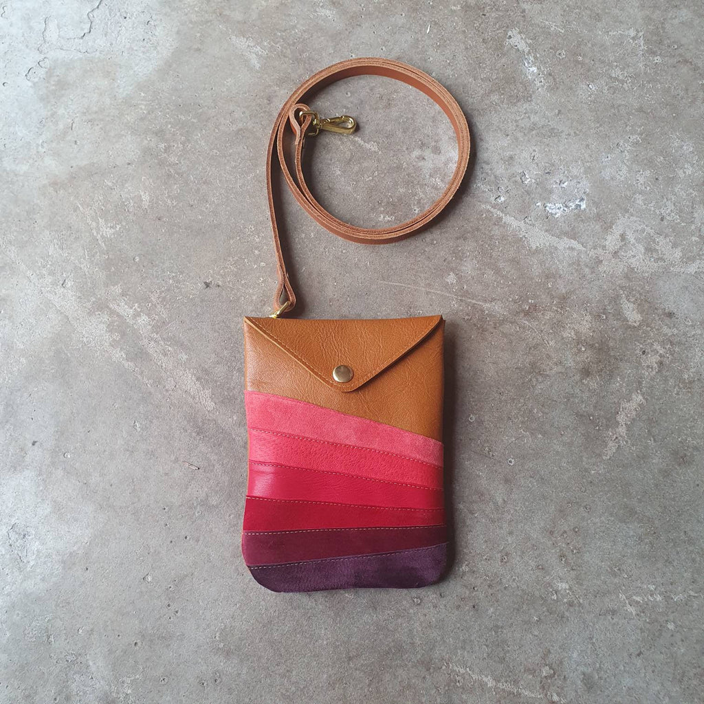 Tan leather handmade handbag with multiple shades of red stripes