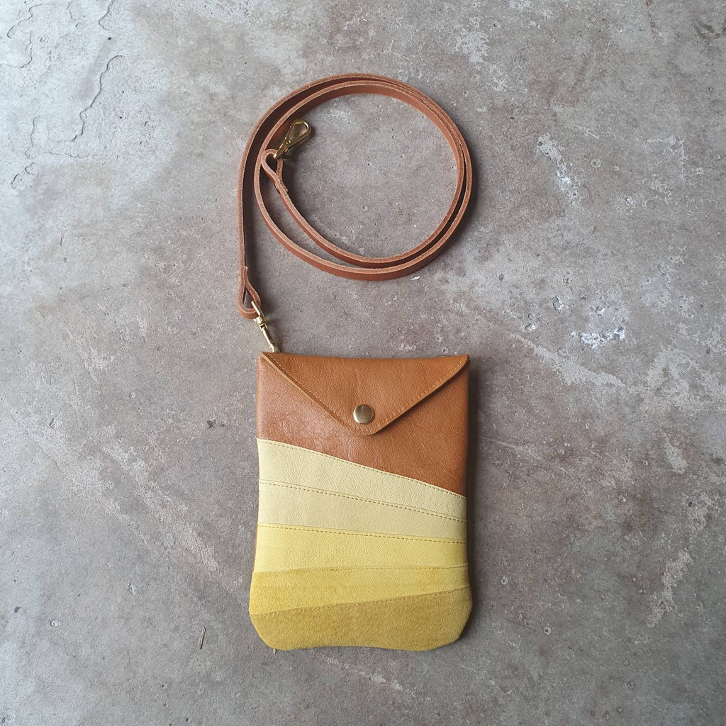 Tan leather crossbody handmade handbag with multiple shades of yellow stripes