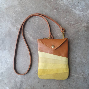 Tan leather crossbody handmade handbag with multiple shades of yellow stripes